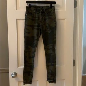 Camo skinny jeans with frayed ankles.